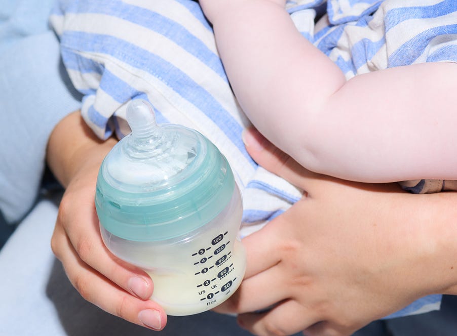 a mum bottle feeding her baby