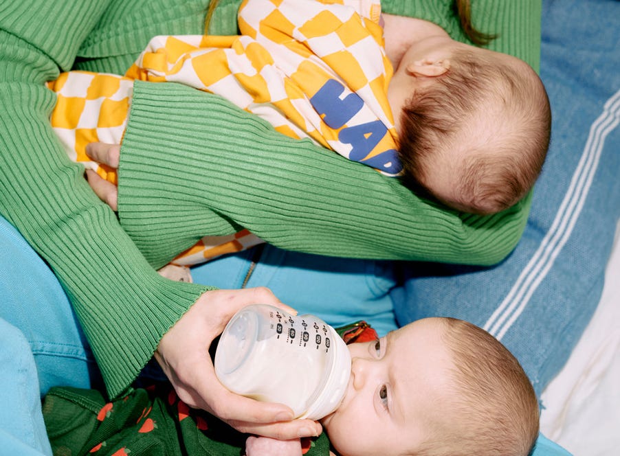 a mum bottle feeding and breastfeeding twins