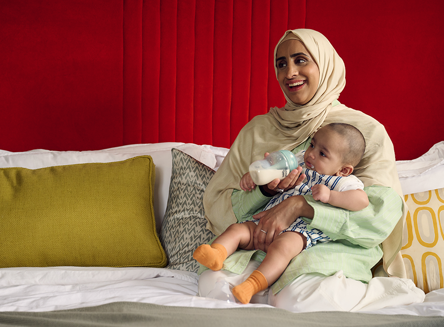 mum with baby and anti-colic bottle