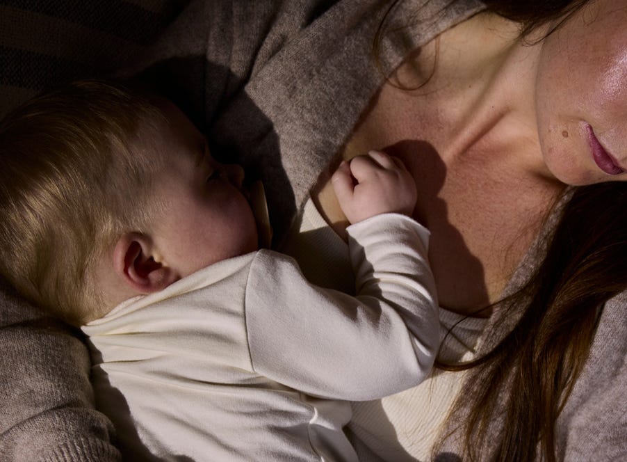 a baby sleeping on their mum's chest