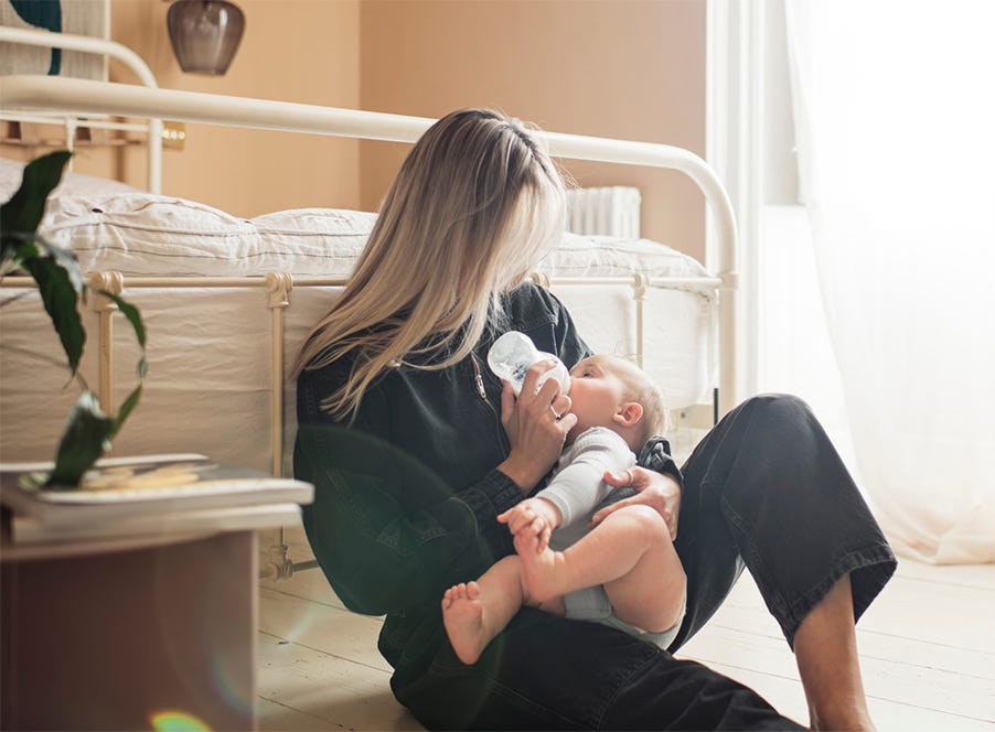 mum sitting on the floor with her baby