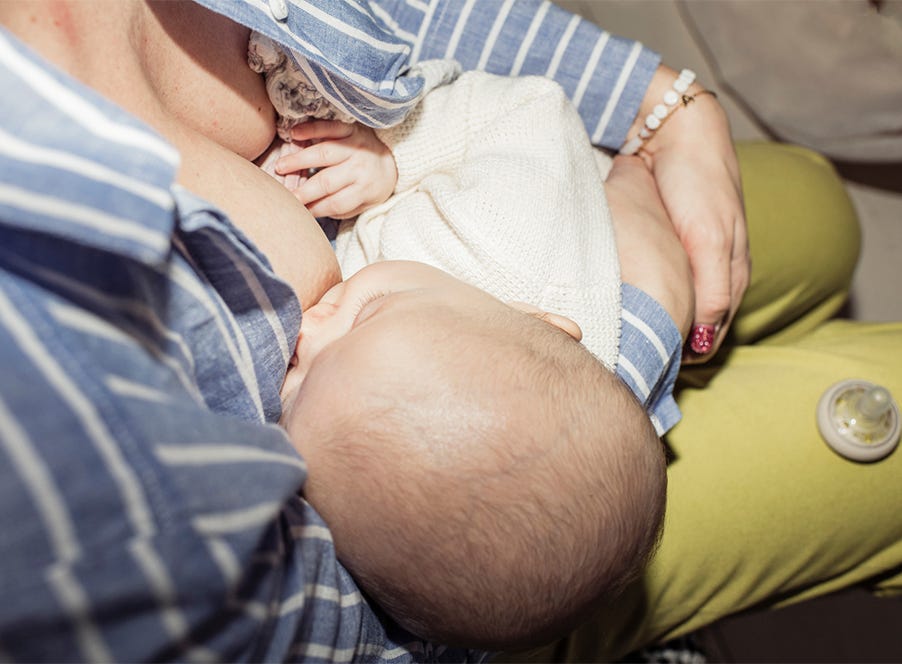 a mum breastfeeding her newborn baby