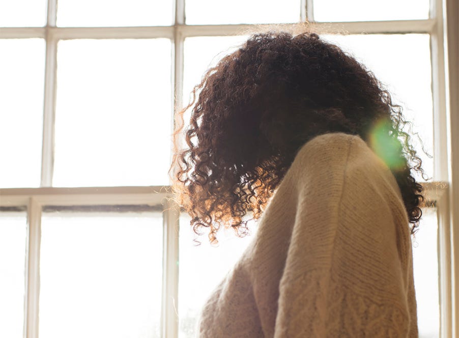 a woman looking out of a window