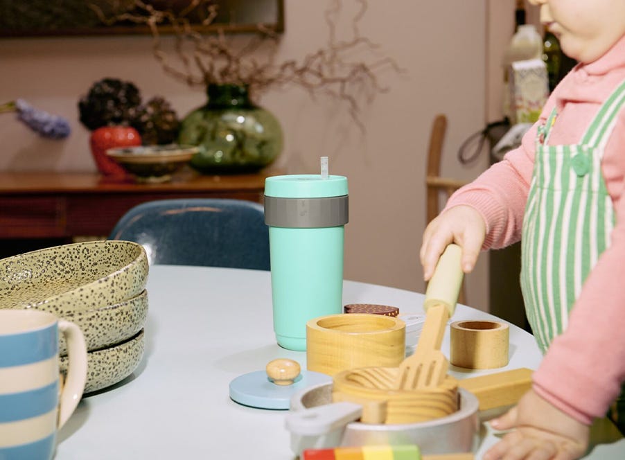 a toddler playing with wooden food