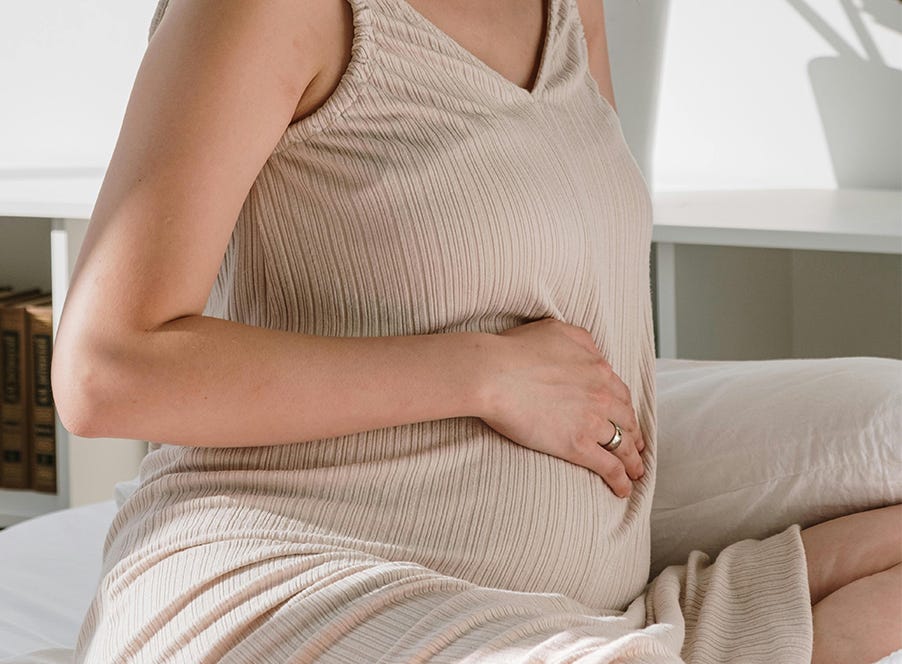 a pregnant woman holding her baby bump