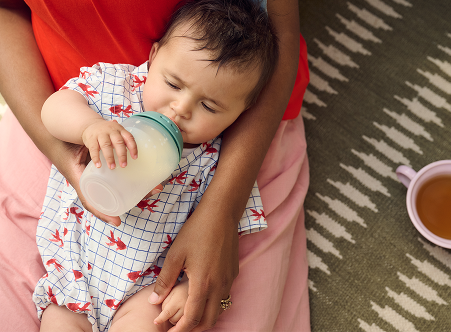 a mum holding her baby and a bottle