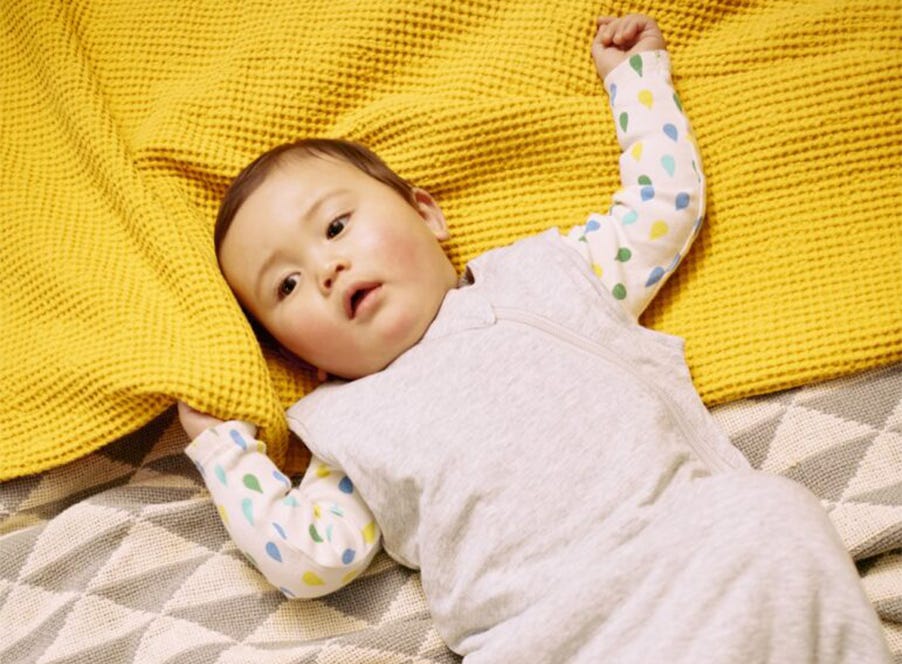 a baby wearing a sleepbag