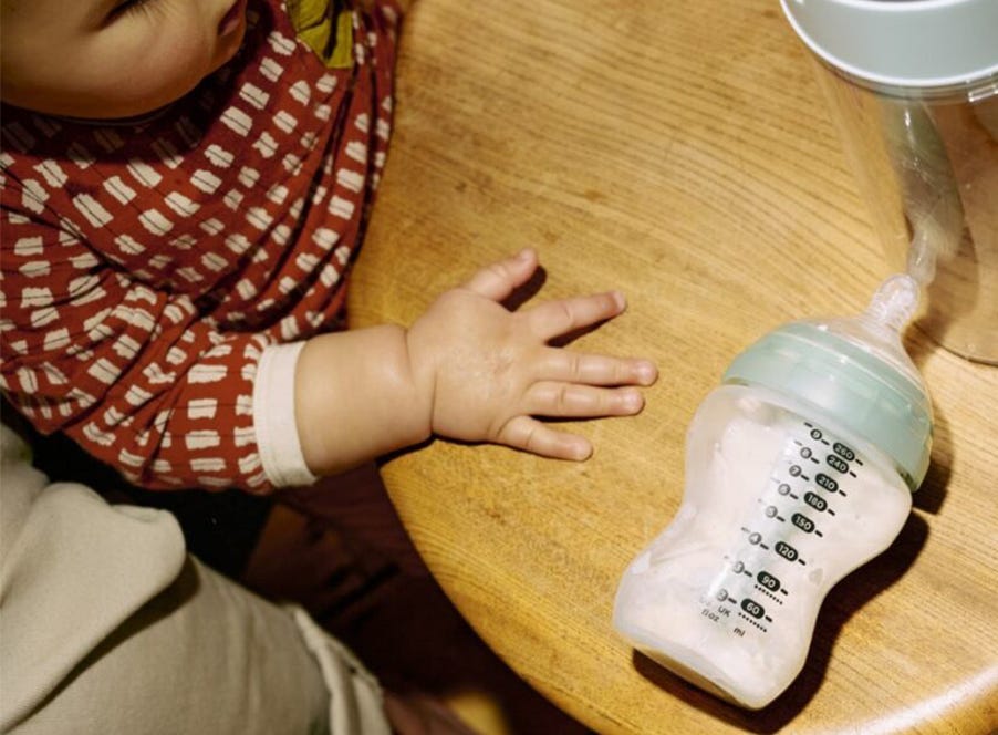 a baby and a tommee tippee bottle
