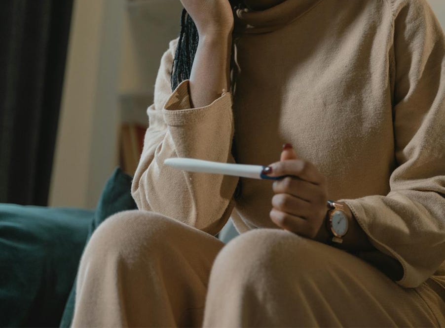 a woman holding a pregnancy test