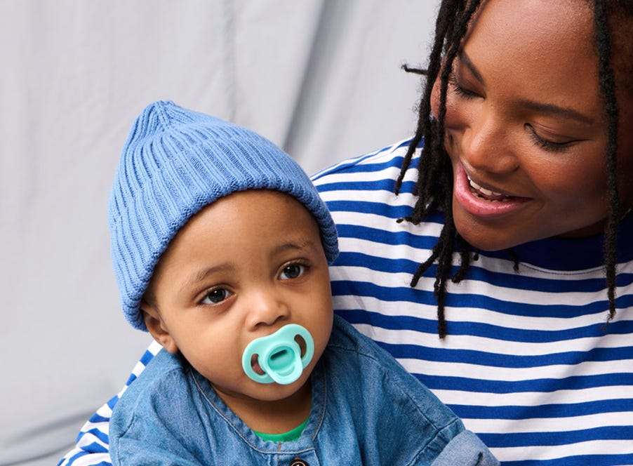 a baby wearing a blue beanie hat
