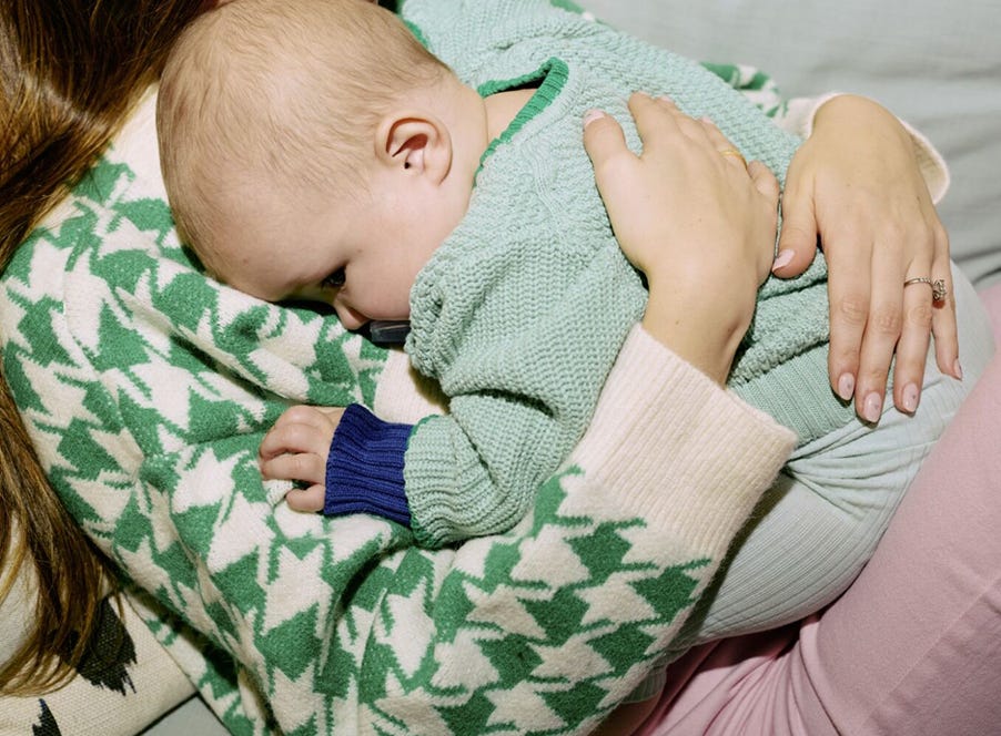 a mum with her baby sitting on her knee