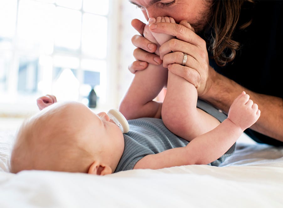 a dad changing his baby's nappy