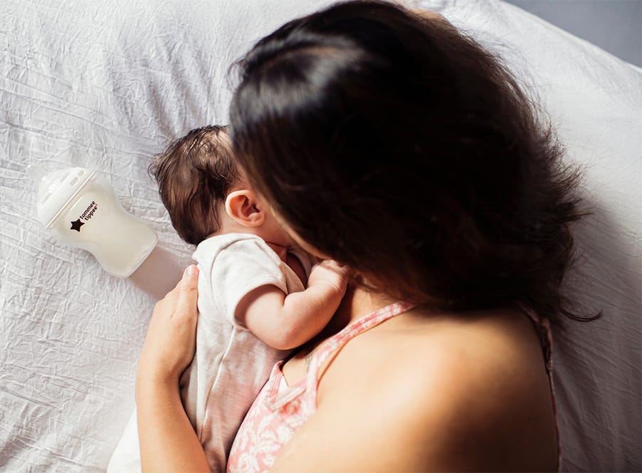 a mum lying down with her baby