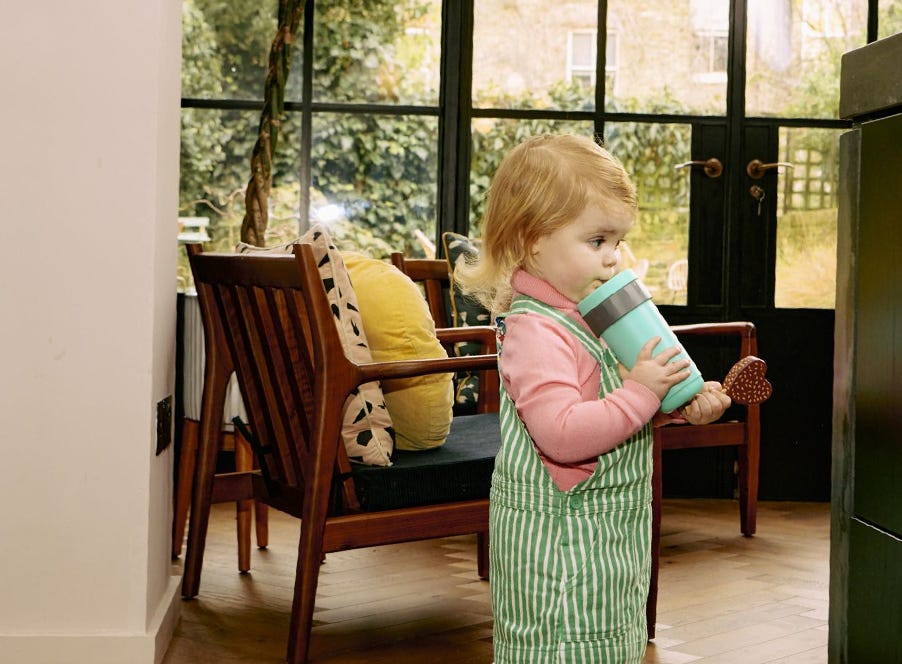 a toddler walking around a house