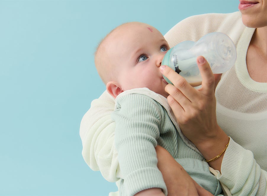 a mum bottle feeding her baby