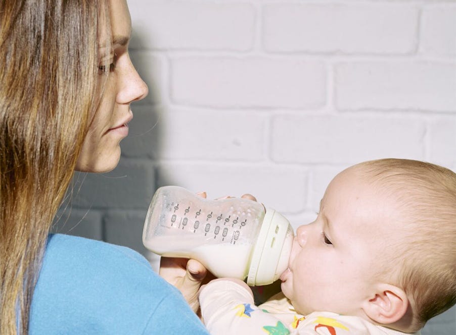 a mum bottle feeding her baby
