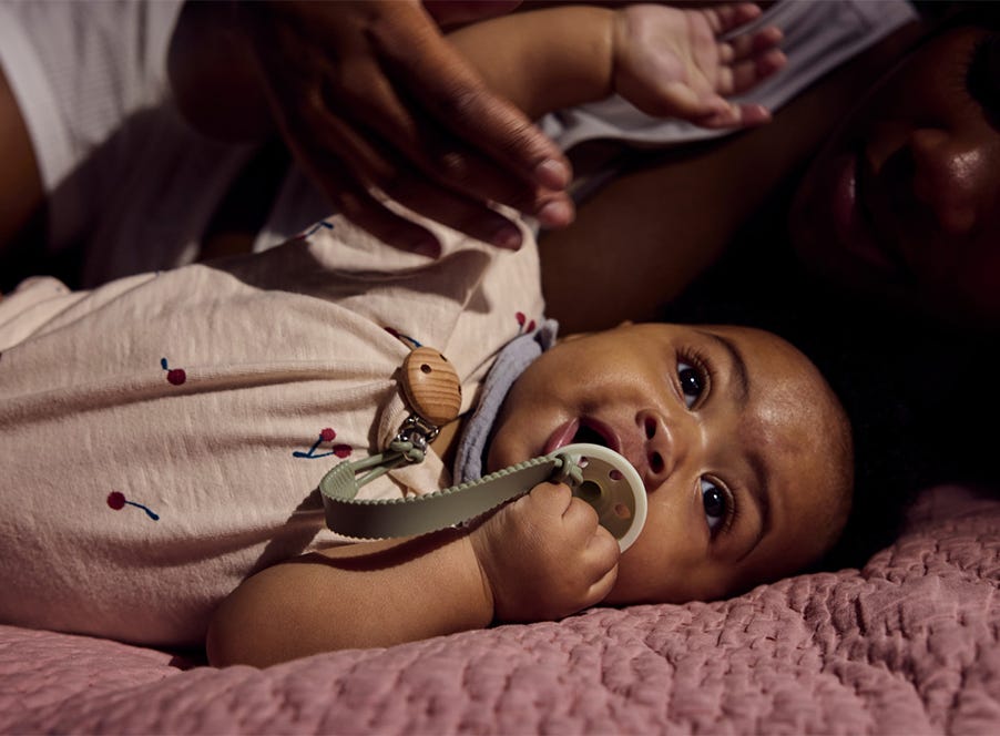 a baby lying in bed