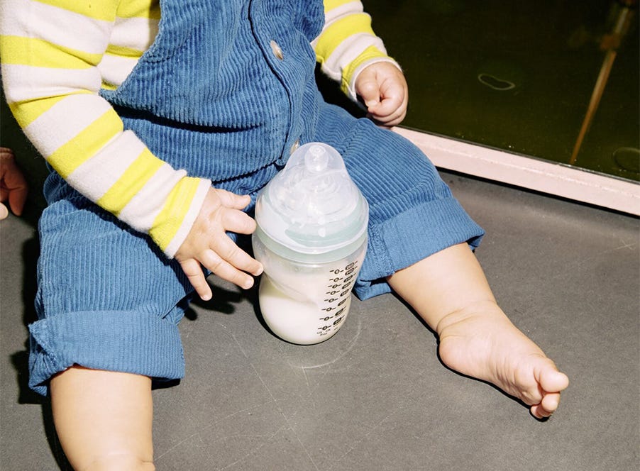 a baby holding a bottle