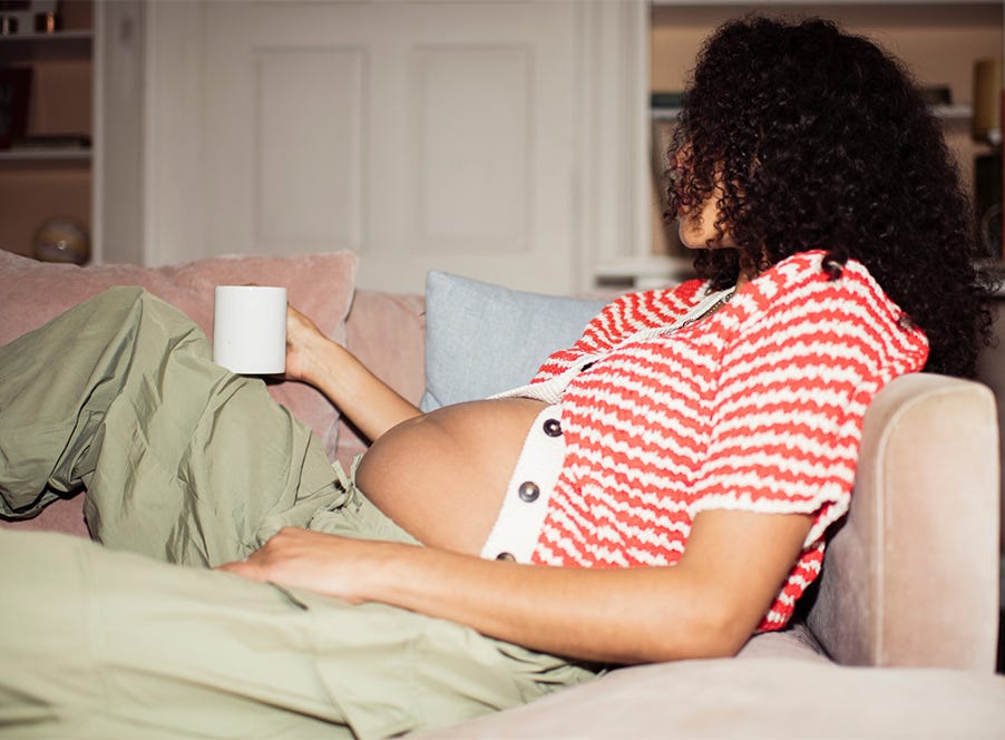 a pregnant mum drinking tea
