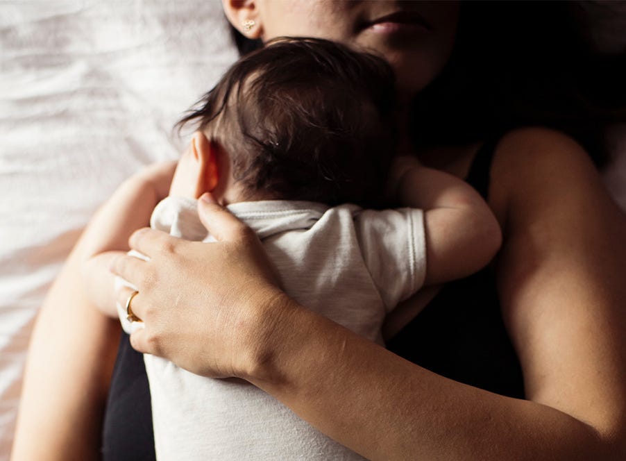 a mum holding her baby