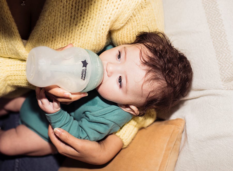 a mum bottle feeding her baby