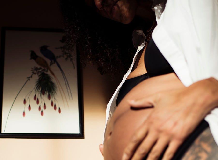 a mum holding her baby bump