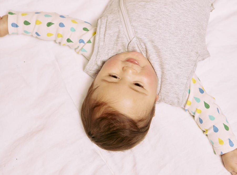 a baby lying in bed