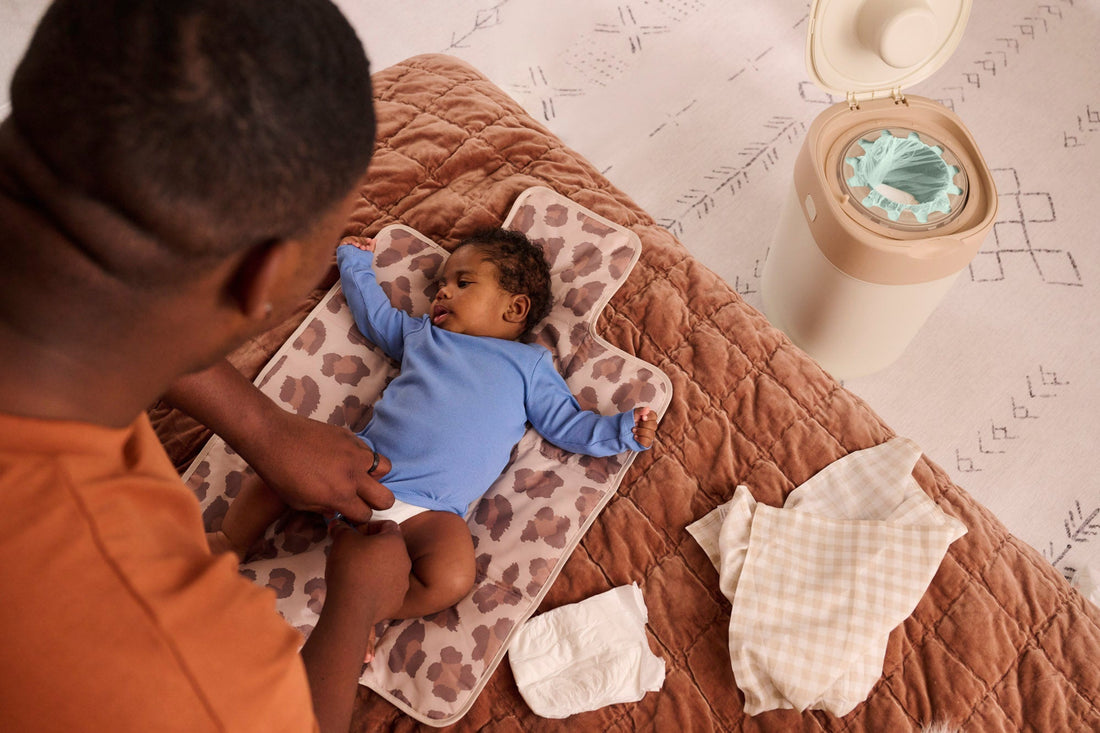 dad changing baby's nappy