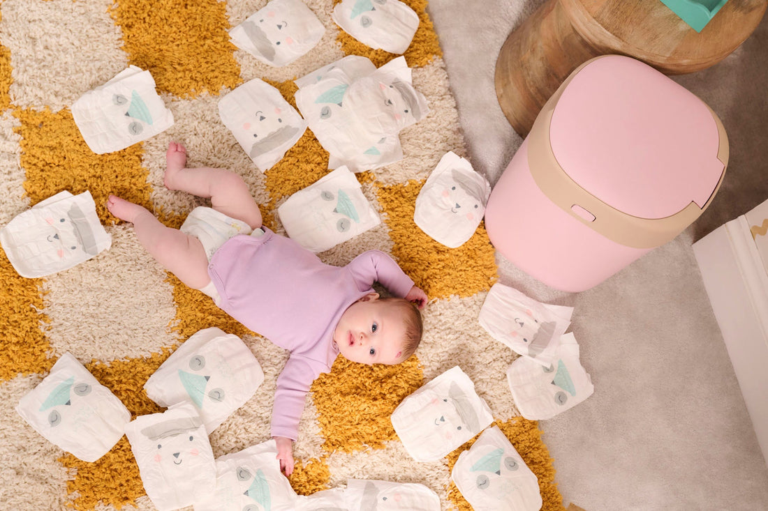 baby lying down surrounded by nappies