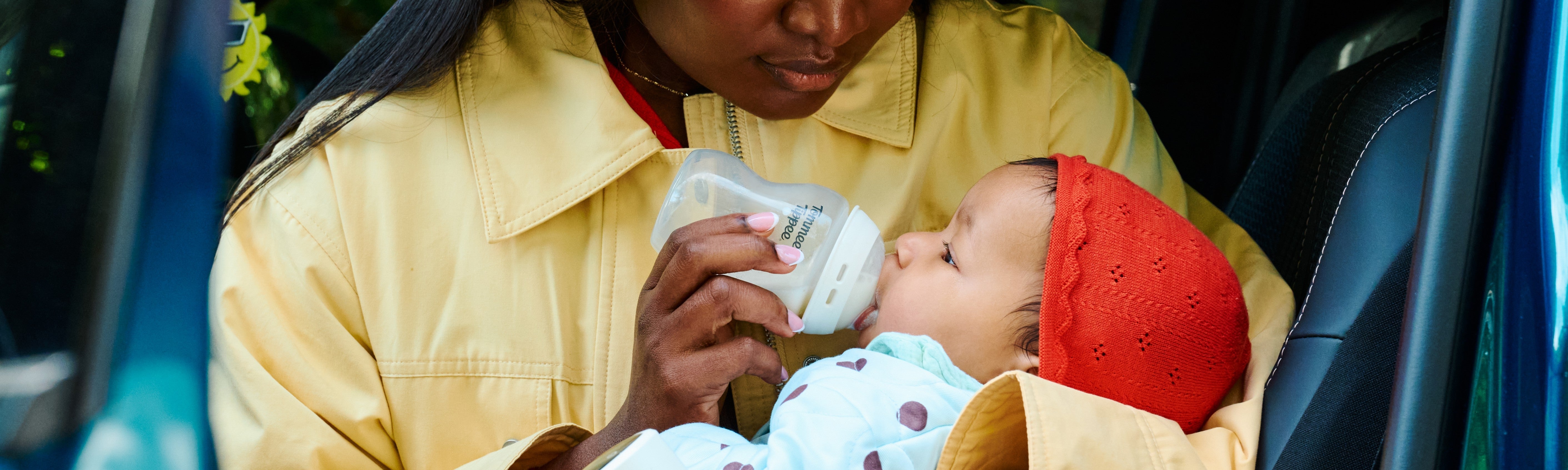 mum feeding baby bottle