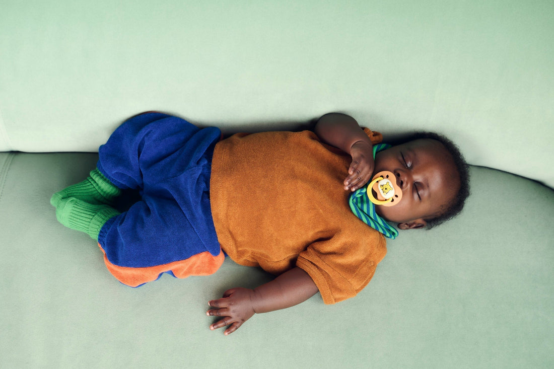 baby asleep with dummy in mouth