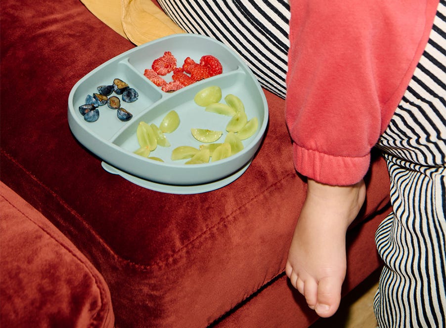 a baby eating fruit