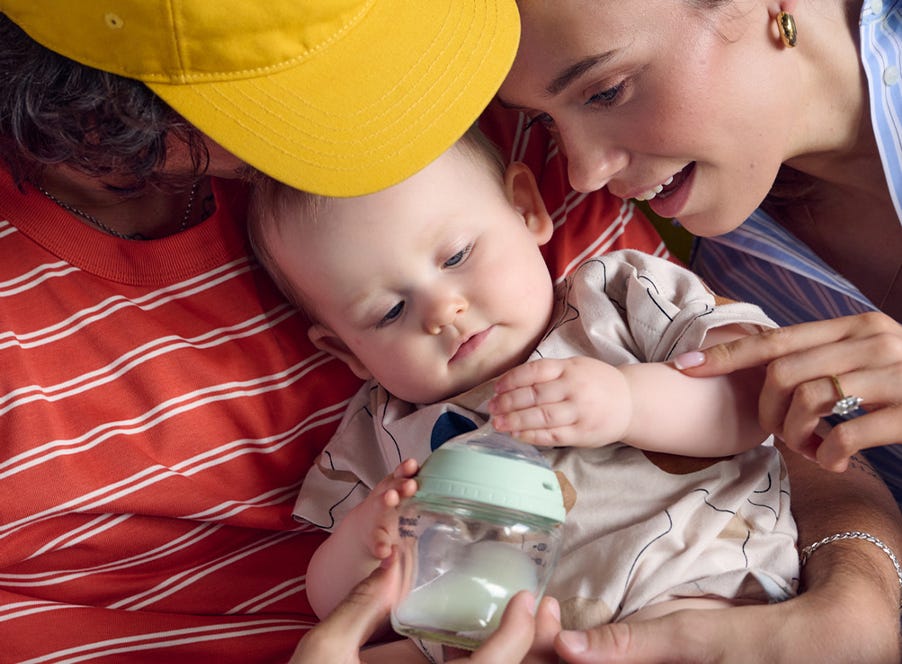 two parents holding their baby