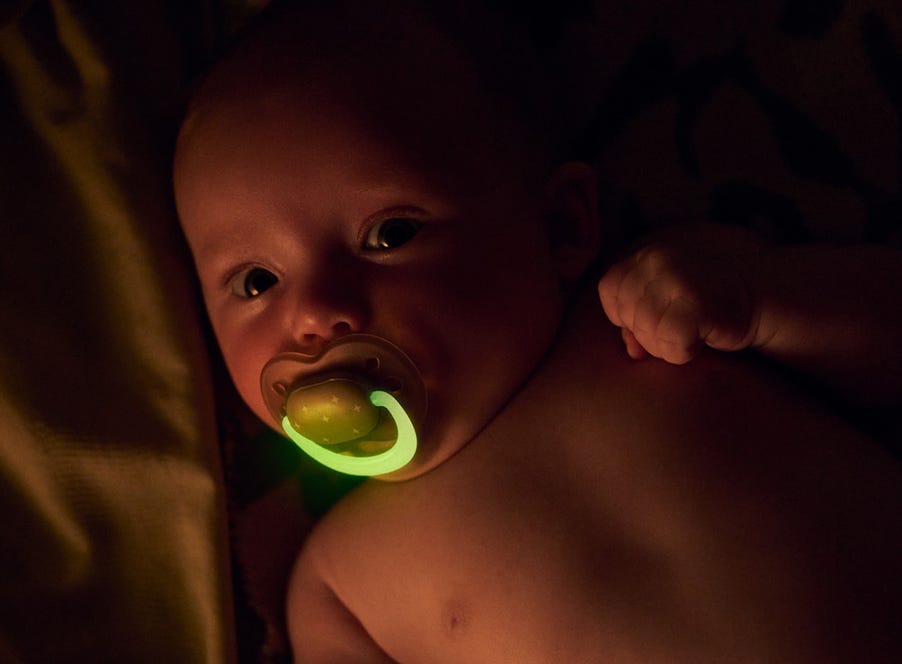 a baby with a soother in their mouth