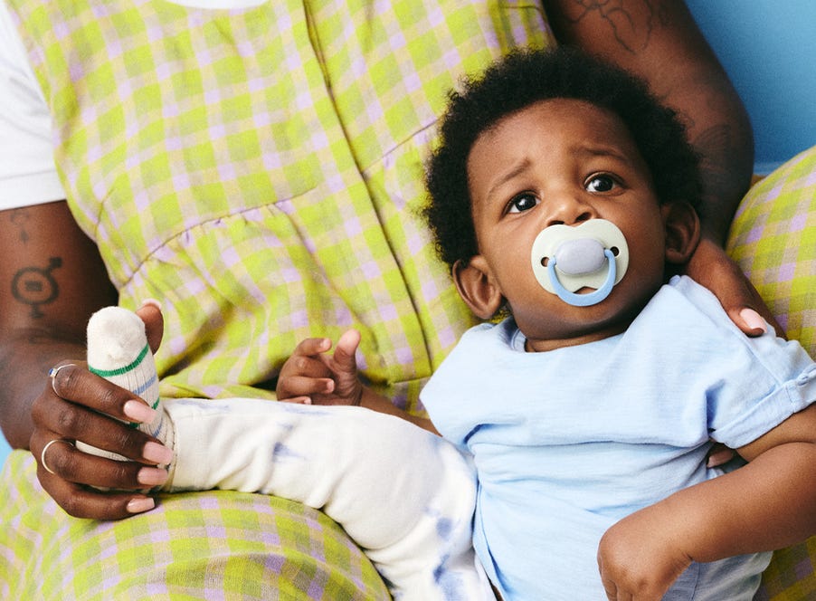 a baby using a soother from tommee tippee