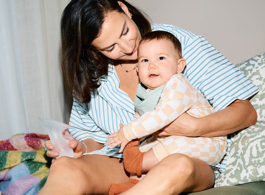 mum holding her baby and a silicone breast pump