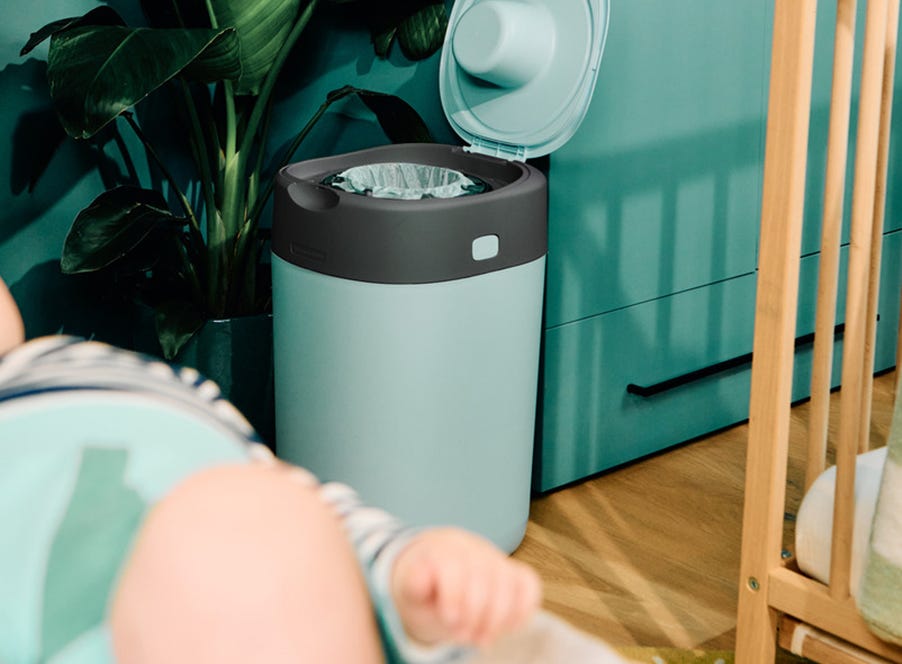 a blue nappy bin with the lid open