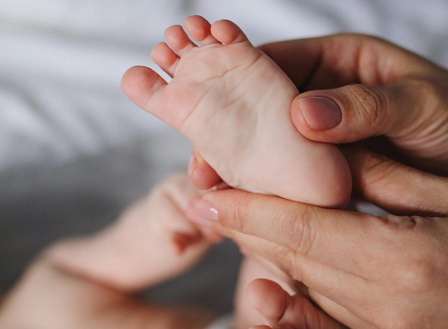 a mum holding her baby's foot