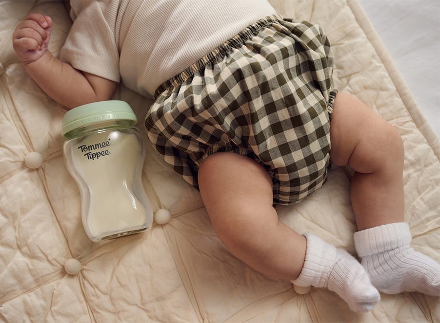 a baby and a tommee tippee bottle
