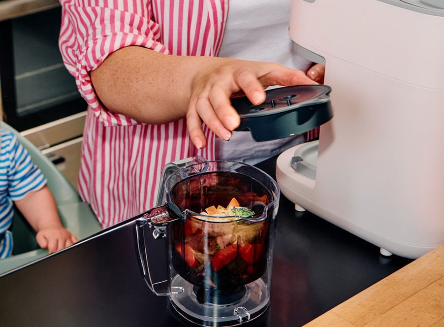 a mum making baby food in a blender