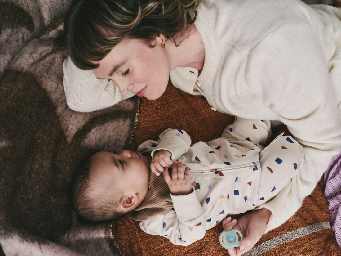 mother and baby on bed