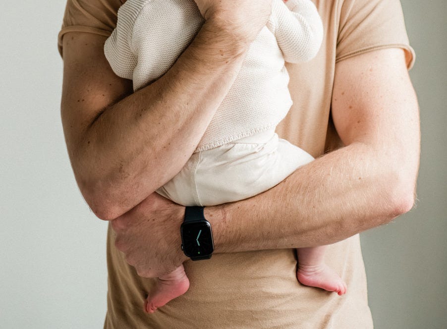 a dad holding his newborn baby