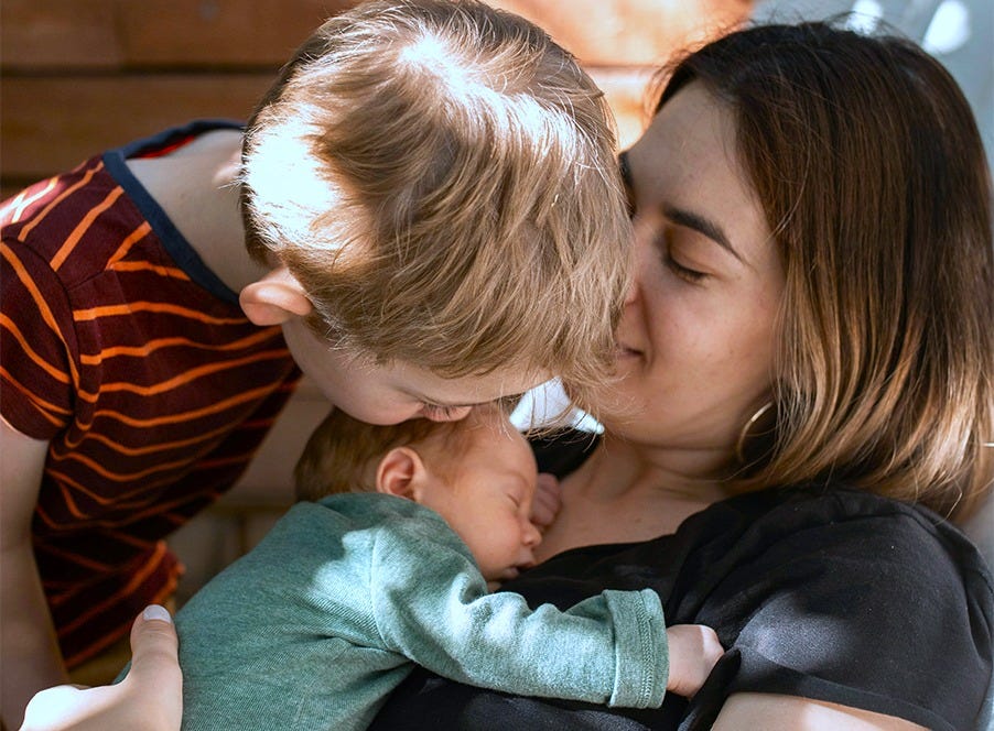 a mum, toddler and newborn baby