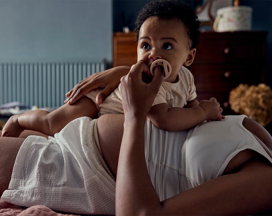 a baby lying on their mums stomach