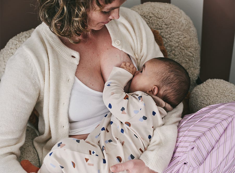a postpartum mum breastfeeding her baby