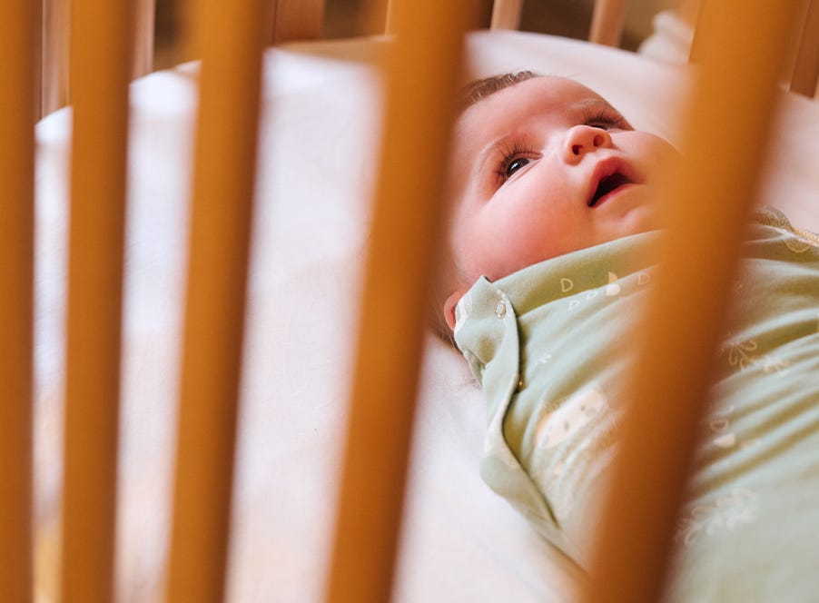 a baby in their cot