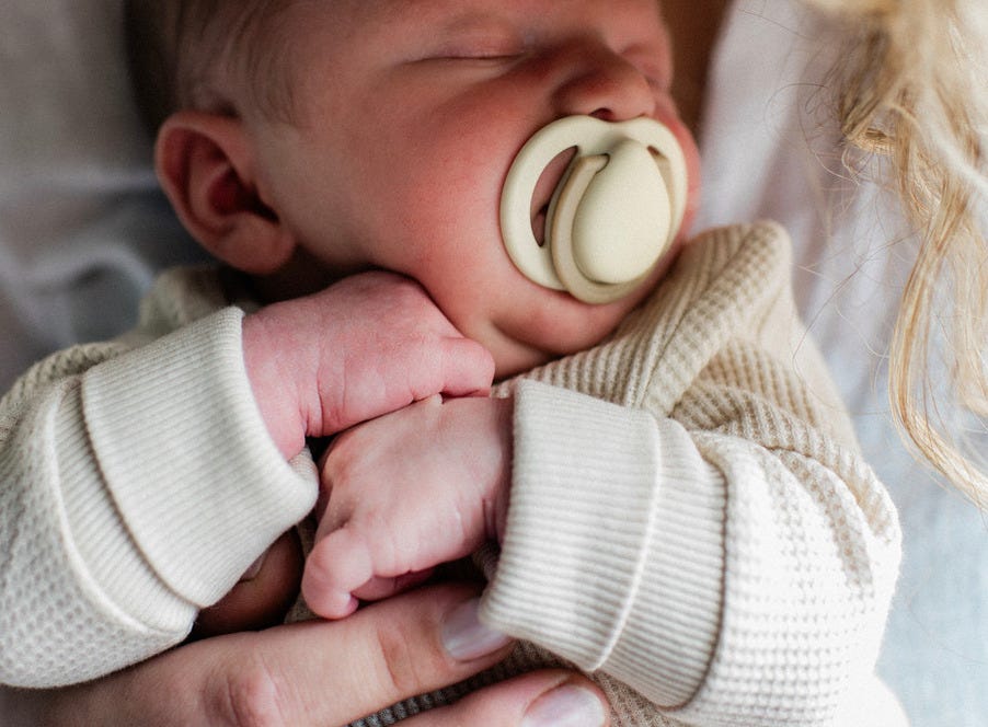 a newborn baby being held