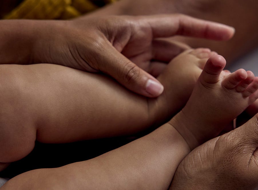 a mum holding her baby's feet