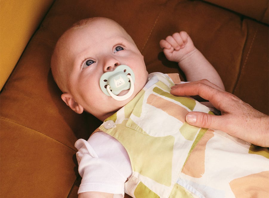 a baby using a tommee tippee soother
