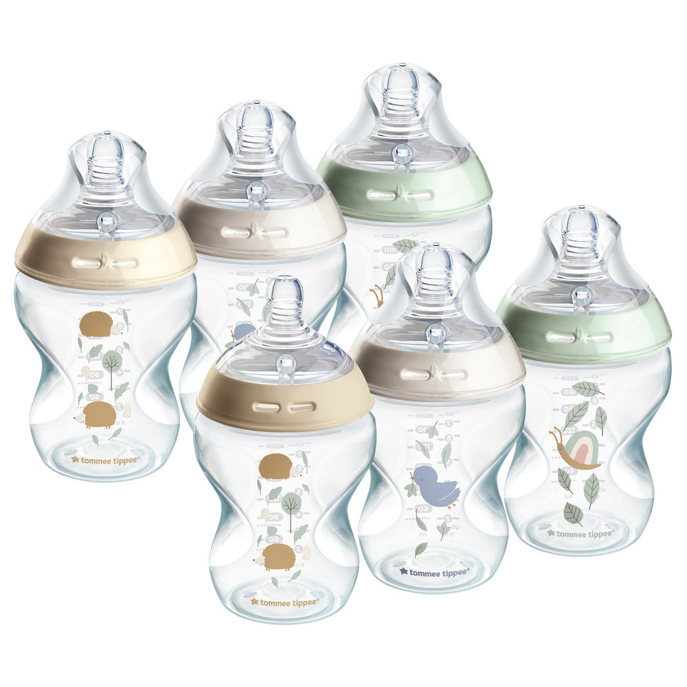 Set of baby bottles with decorative elements on a white background